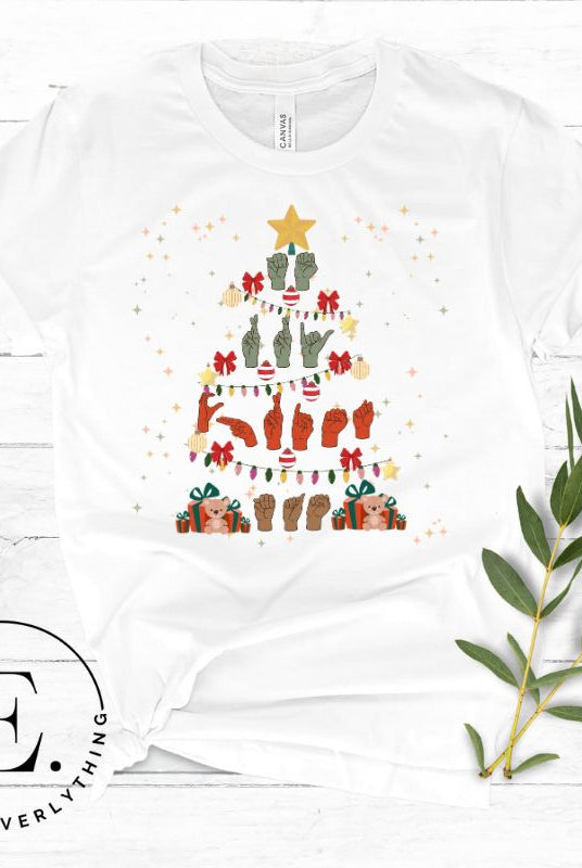 Add festive cheer with this ASL Merry Christmas t-shirt. The hands skillfully shape the words 'Merry Christmas' in American Sign Language, forming a beautiful Christmas tree design on a white colored shirt.