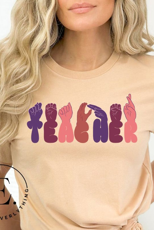 Let's celebrate our educators with this unique ASL teacher t-shirt. The word "teacher" is spelled out in American Sign Language using expertly crafted hands, highlighting their vital role in shaping our society. ASL teacher on a soft cream colored shirt.