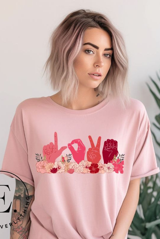 ASL hands signing love in floral flowers on a pink colored shirt.