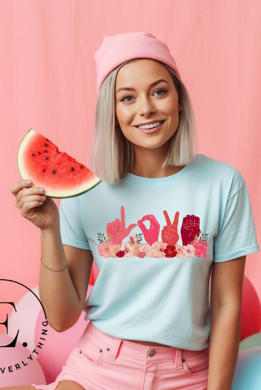 Express love in a unique way with our downloadable PNG sublimation t-shirt design! Featuring American Sign Language (ASL) hands spelling 'Love' adorned with beautiful flowers on a light blue shirt. 