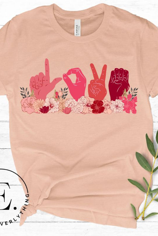 ASL hands signing love in floral flowers on a peach colored shirt.