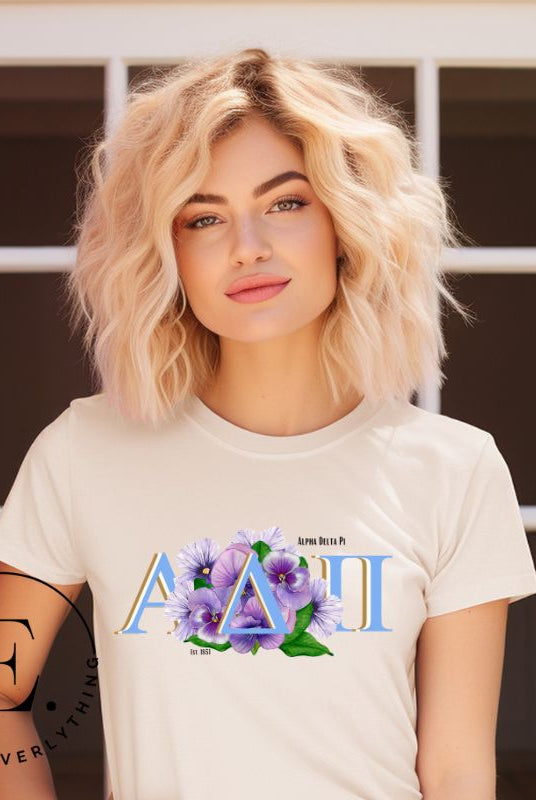 Show your Alpha Delta Pi pride with our stylish t-shirt featuring the sorority letters and the iconic violet, their symbolic flower on a tan shirt.
