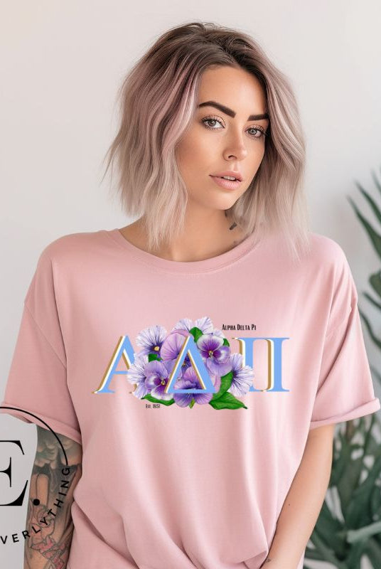 Show your Alpha Delta Pi pride with our stylish t-shirt featuring the sorority letters and the iconic violet, their symbolic flower on a pink shirt. 