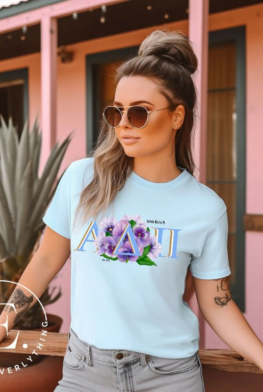Show your Alpha Delta Pi pride with our stylish t-shirt featuring the sorority letters and the iconic violet, their symbolic flower on a blue shirt. 