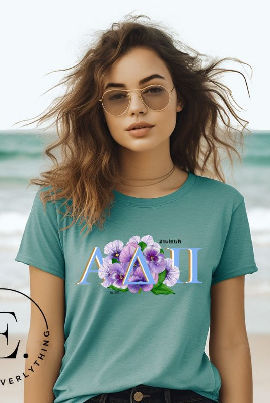 Elevate your Alpha Delta Pi sisterhood with our exclusive sublimation t-shirt download. Featuring the sorority's letters and the timeless violet, their symbolic flower on a teal shirt. 