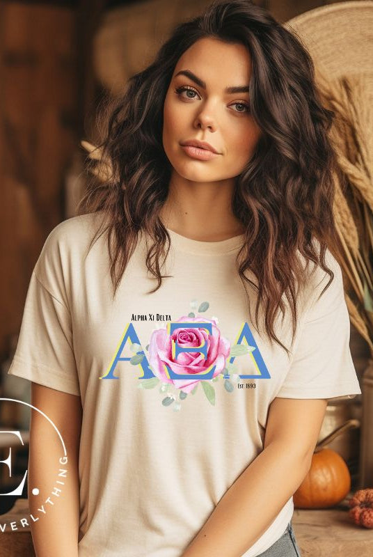 Show your Alpha Xi Delta pride with our stylish t-shirt featuring the sorority's letters and iconic pink rose on a soft cream shirt. 