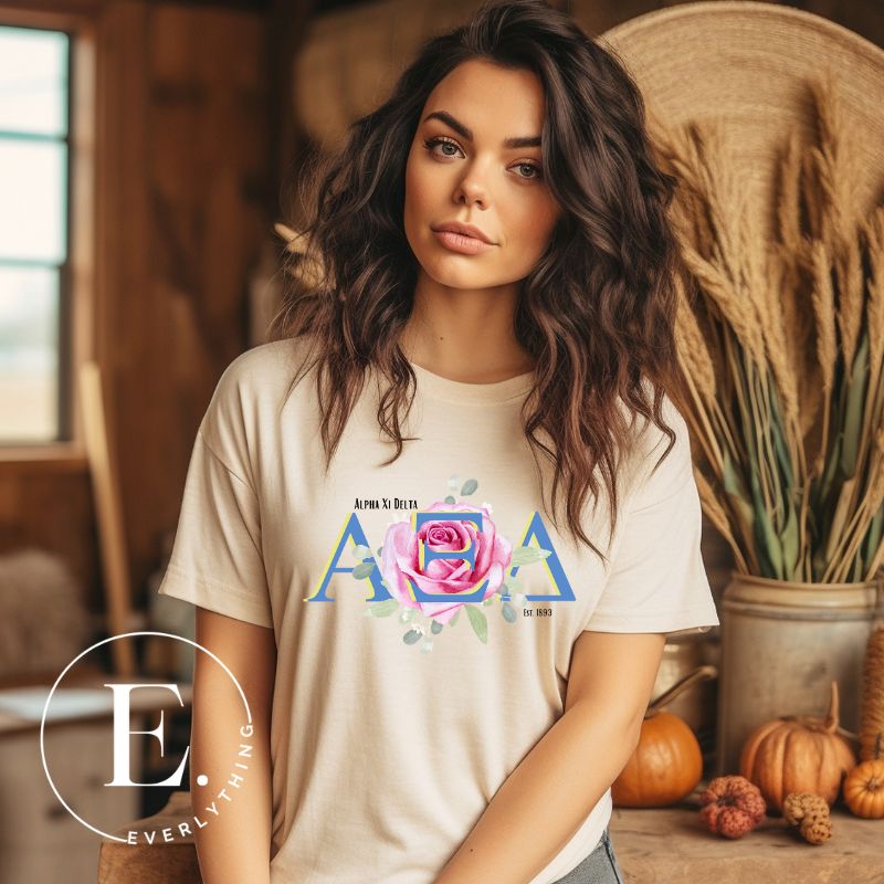 Show your Alpha Xi Delta pride with our stylish t-shirt featuring the sorority's letters and iconic pink rose on a soft cream shirt. 