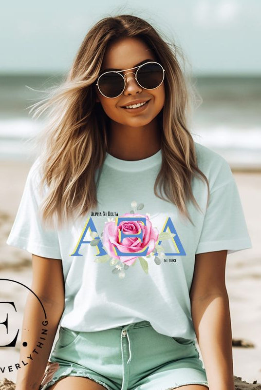 Show your Alpha Xi Delta pride with our stylish t-shirt featuring the sorority's letters and iconic pink rose on a mint shirt. 