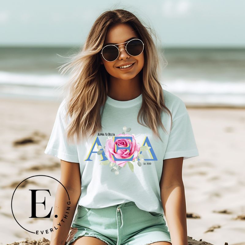 Show your Alpha Xi Delta pride with our stylish t-shirt featuring the sorority's letters and iconic pink rose on a mint shirt. 