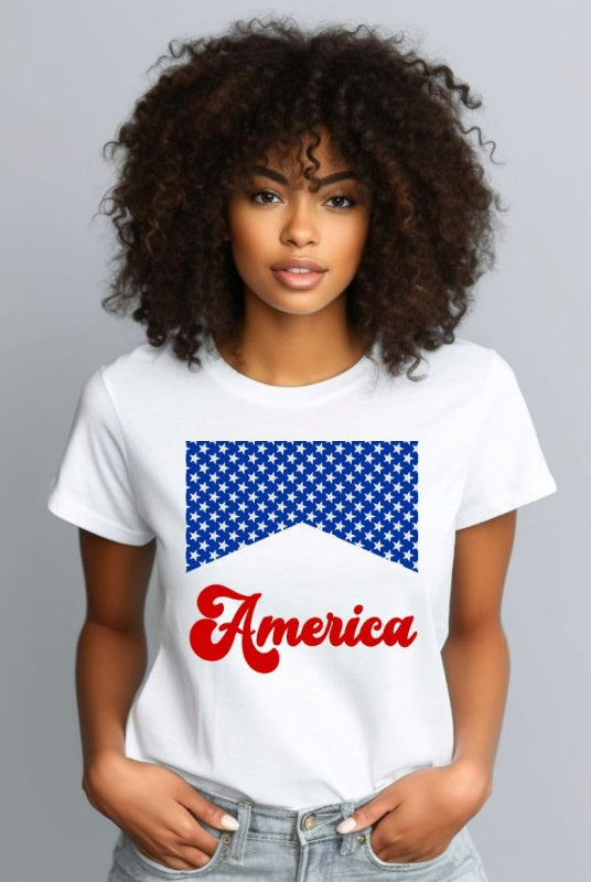 Close-up image of a USA July 4th graphic tee with the word 'America' spelled out in retro lettering on the front. The lettering is filled with iconic American flag stars, adding a patriotic touch to the design on white graphic tee.