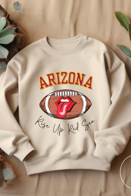 Support the Arizona Cardinals in style with our exclusive sweatshirt featuring the team's name and rallying slogan, "Rise Up Red Sea." On a sand sweatshirt. 