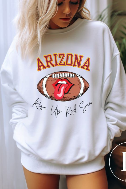 Support the Arizona Cardinals in style with our exclusive sweatshirt featuring the team's name and rallying slogan, "Rise Up Red Sea." On a white sweatshirt. 