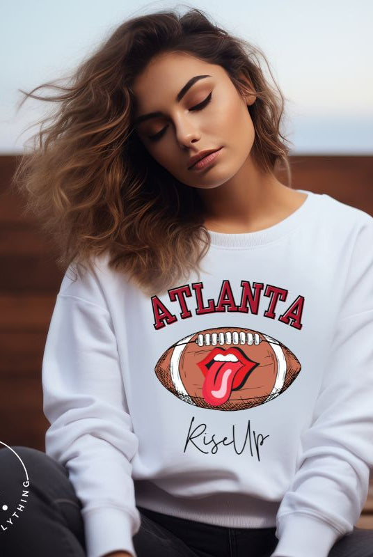 Show your Atlanta Falcons pride with our cozy and warm sweatshirt featuring the team's name and empowering slogan, "Rise Up." On a white sweatshirt.