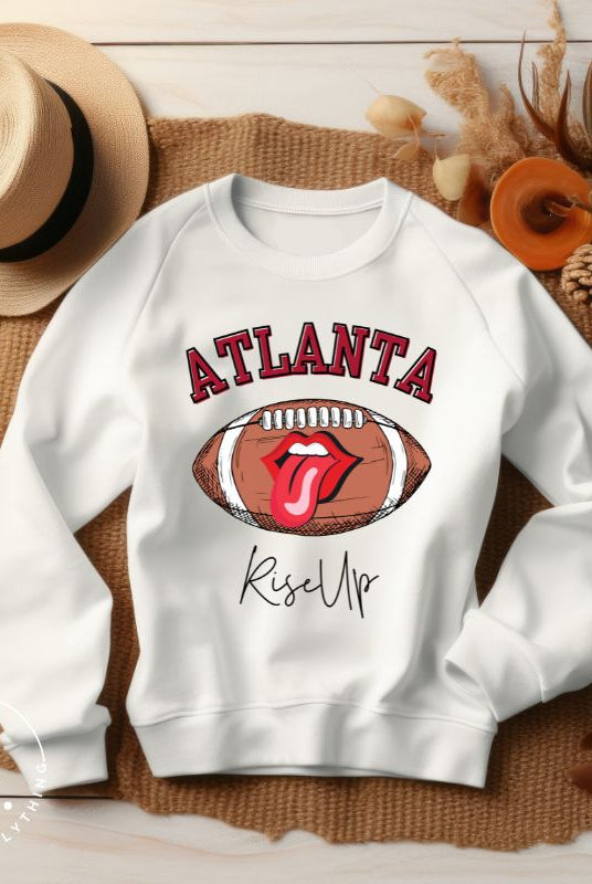 Show your Atlanta Falcons pride with our cozy and warm sweatshirt featuring the team's name and empowering slogan, "Rise Up." On a white sweatshirt. 