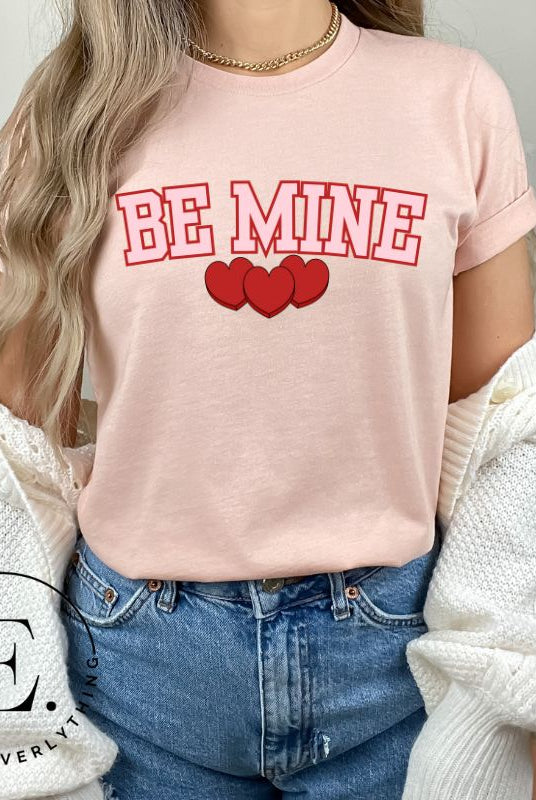 Make your Valentine's Day celebrations even more special with our PNG sublimation digital download! You can create unique and personalized shirts featuring the charming phrase "Be Mine" in a trendy and eye-catching design. Example on Be Mine PNG sublimation on a peach shirt. 