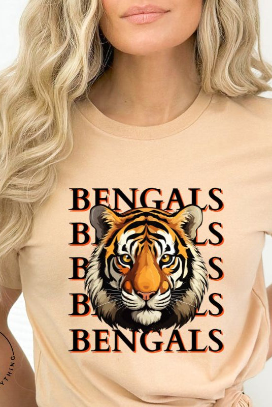 Our exclusive design features a fierce Siberian tiger face and the spirited mantra "Bengals Bengals Bengals Bengals." Unleash your inner roar with our comfortable Bella Canvas 3001 unisex graphic tee and show your stripes as a Cincinnati Bengals fan on a tan shirt. 