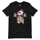 Black t-shirt featuring a detailed skeleton design with ribcage and hands intertwined with soft, colorful flowers, blending gothic and floral aesthetics.