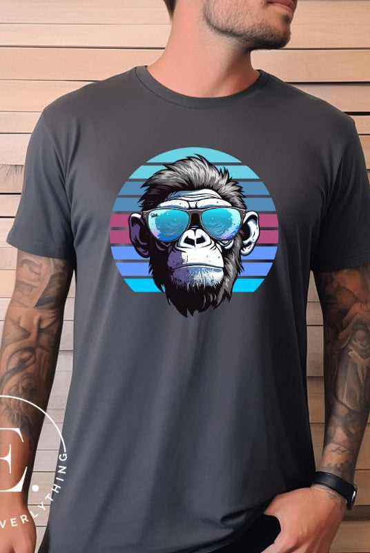 Hyper-realistic gorilla wearing sunglasses with a retro blue horizon behind on a dark grey colored shirt.