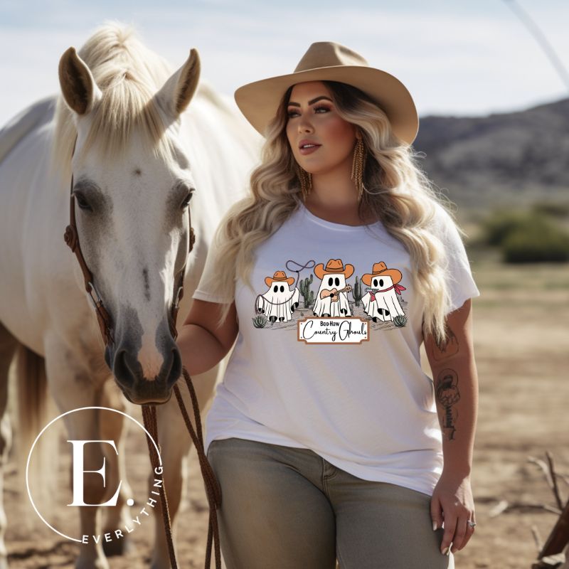 Get ready for a boot-stompin' Halloween with our country-themed PNG sublimation download. Featuring ghostly cowboys in cowboy hats, lassos, and playing country music, all accompanied by the catchy saying 'Boo-Haw Country Ghouls.' PNG example on a white shirt. 