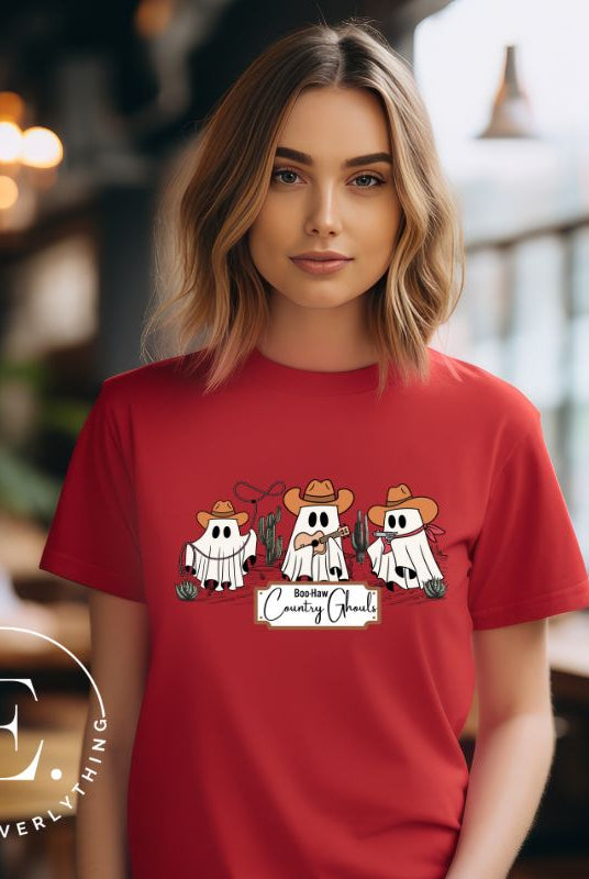 Get ready for a boot-stompin' Halloween with our country-themed PNG sublimation download. Featuring ghostly cowboys in cowboy hats, lassos, and playing country music, all accompanied by the catchy saying 'Boo-Haw Country Ghouls.' PNG example on a red shirt. 