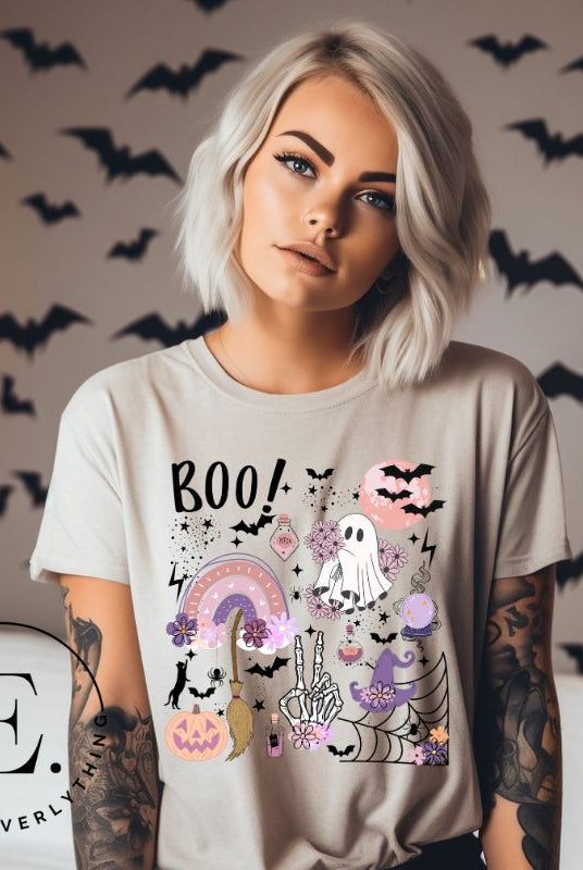 Experience the essence of Halloween with our bewitching shirt. Immerse yourself in a tapestry of Halloween symbols, from pumpkins to bats and witches, and all centered around the timeless exclamation, 'Boo!' This captivating design embodies the spirit of the season, on a tan shirt. 