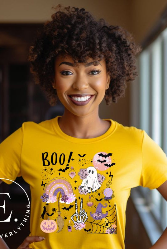 Experience the essence of Halloween with our bewitching shirt. Immerse yourself in a tapestry of Halloween symbols, from pumpkins to bats and witches, and all centered around the timeless exclamation, 'Boo!' This captivating design embodies the spirit of the season, on a yellow shirt. 