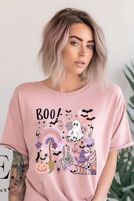 Experience the essence of Halloween with our bewitching shirt. Immerse yourself in a tapestry of Halloween symbols, from pumpkins to bats and witches, and all centered around the timeless exclamation, 'Boo!' This captivating design embodies the spirit of the season, on a pink shirt. 