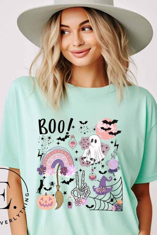 Experience the essence of Halloween with our bewitching shirt. Immerse yourself in a tapestry of Halloween symbols, from pumpkins to bats and witches, and all centered around the timeless exclamation, 'Boo!' This captivating design embodies the spirit of the season, on a mint shirt. 