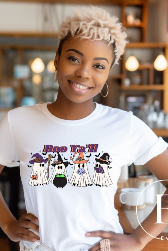 Embrace the spirit of Halloween with our spooktacular shirt. Join a mischievous gang of ghostly trick-or-treaters as they spread frightening fun. Featuring a playful 'Boo Ya'll' message, on a white shirt. 