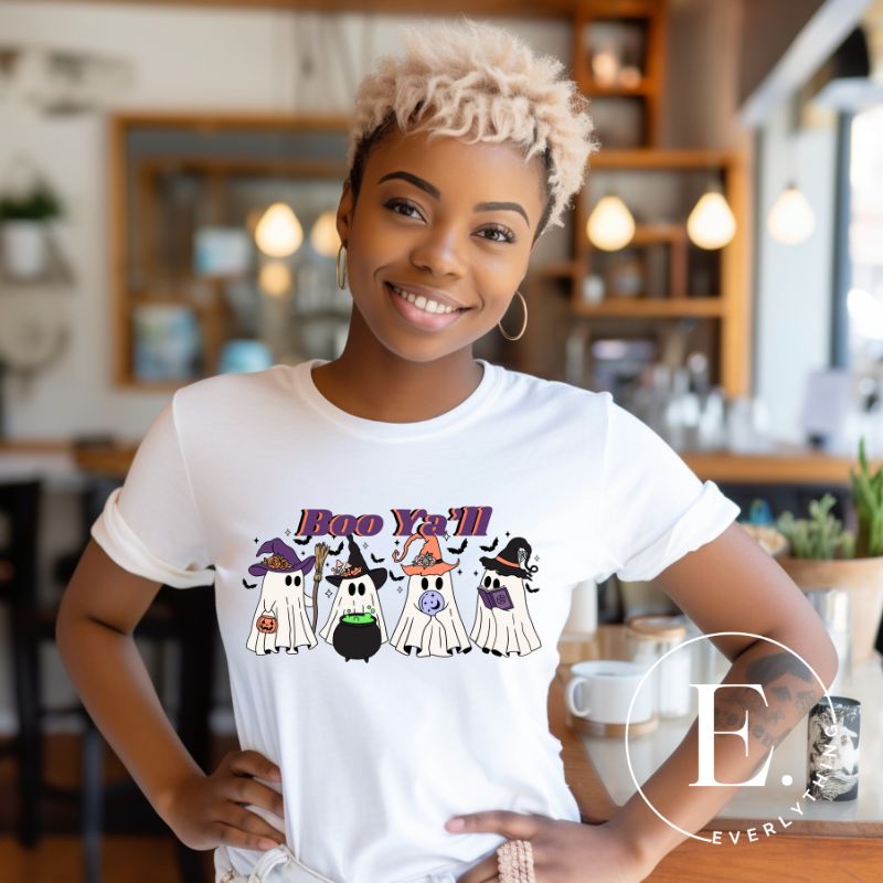 Get into the Halloween spirit with our adorable PNG sublimation download. Four cute ghost going trick-or-treating, accompanied by the playful saying 'Boo Ya'll.' PNG example on a white shirt. 