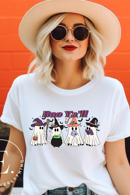 Get into the Halloween spirit with our adorable PNG sublimation download. Four cute ghost going trick-or-treating, accompanied by the playful saying 'Boo Ya'll.' PNG example on a white shirt. 