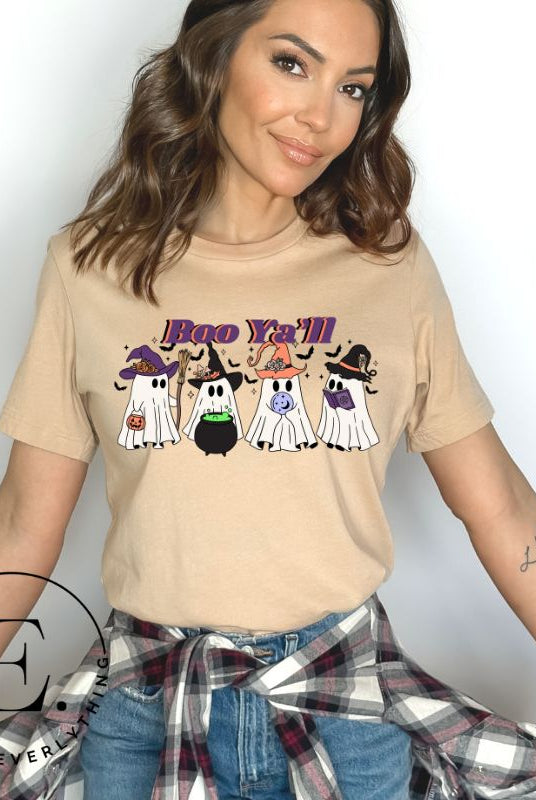 Get into the Halloween spirit with our adorable PNG sublimation download. Four cute ghost going trick-or-treating, accompanied by the playful saying 'Boo Ya'll.' PNG example on a tan shirt. 