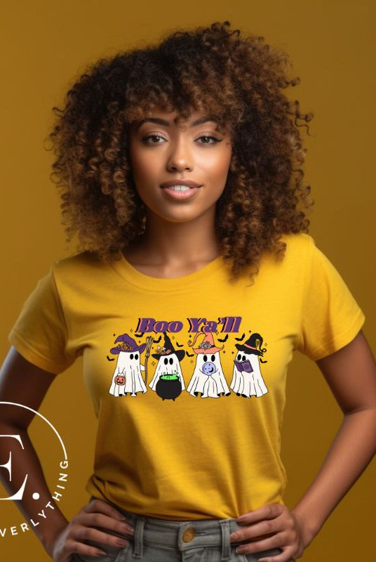 Get into the Halloween spirit with our adorable PNG sublimation download. Four cute ghost going trick-or-treating, accompanied by the playful saying 'Boo Ya'll.' PNG example on a yellow shirt. 