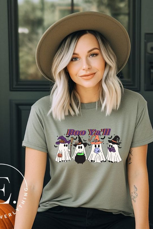 Get into the Halloween spirit with our adorable PNG sublimation download. Four cute ghost going trick-or-treating, accompanied by the playful saying 'Boo Ya'll.' PNG example on a green shirt. 