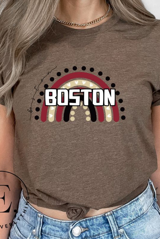 Show off your pride with this Boston College t-shirt. The iconic BC school colors stands out in this modern and trendy rainbow background, representing the school spirit. With the classic Boston wordmark across the rainbow on a brown shirt. 
