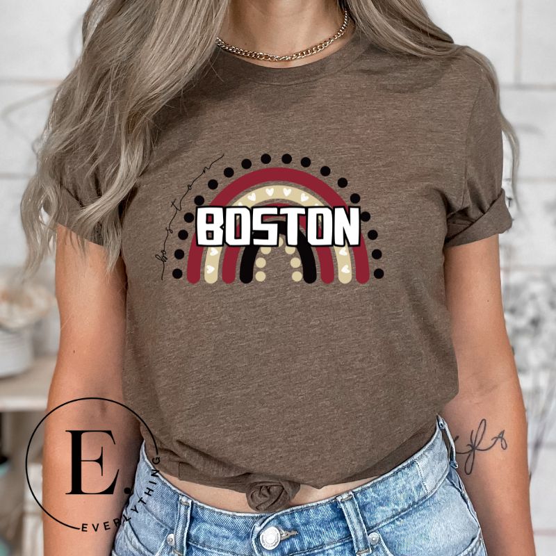 Show off your pride with this Boston College t-shirt. The iconic BC school colors stands out in this modern and trendy rainbow background, representing the school spirit. With the classic Boston wordmark across the rainbow on a brown shirt. 