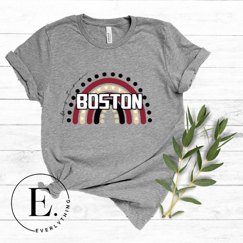 Show off your pride with this Boston College t-shirt. The iconic BC school colors stands out in this modern and trendy rainbow background, representing the school spirit. With the classic Boston wordmark across the rainbow on a grey shirt. 