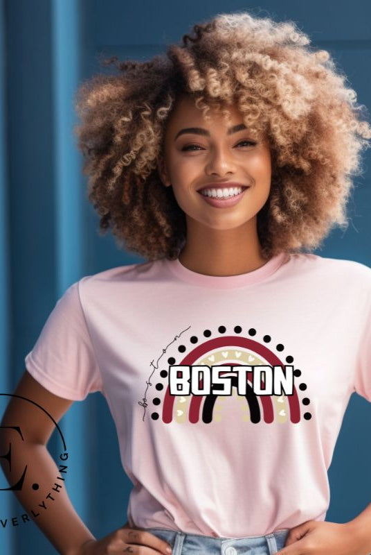 Show off your pride with this Boston College t-shirt. The iconic BC school colors stands out in this modern and trendy rainbow background, representing the school spirit. With the classic Boston wordmark across the rainbow on a light pink shirt. 