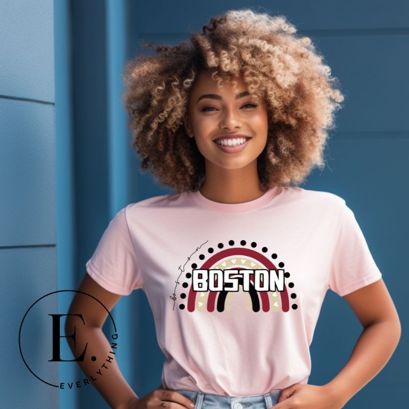Show off your pride with this Boston College t-shirt. The iconic BC school colors stands out in this modern and trendy rainbow background, representing the school spirit. With the classic Boston wordmark across the rainbow on a light pink shirt. 