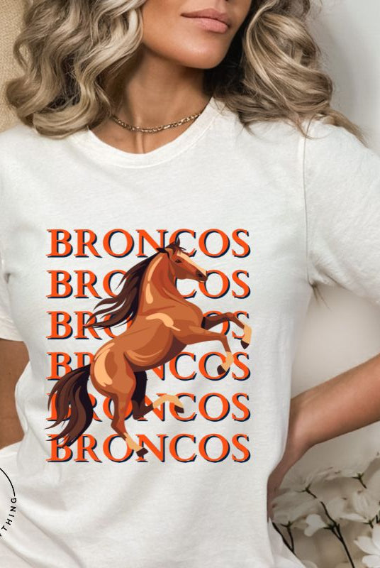 Saddle up for game day fun with our Bella Canvas 3001 unisex graphic tee! Gallop into Broncos spirit with our exclusive design featuring a lively Bronco horse and the spirited mantra "Broncos Broncos Broncos Broncos" on a white shirt. 