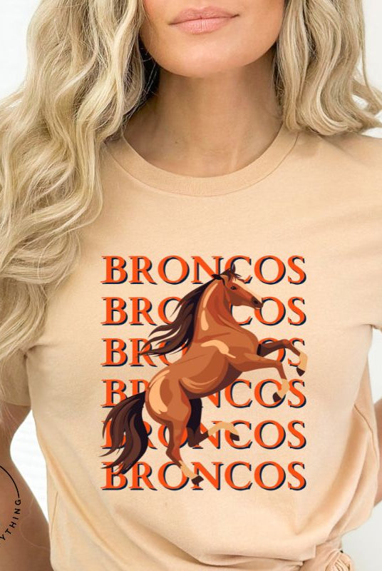 Saddle up for game day fun with our Bella Canvas 3001 unisex graphic tee! Gallop into Broncos spirit with our exclusive design featuring a lively Bronco horse and the spirited mantra "Broncos Broncos Broncos Broncos" on a tan shirt. 