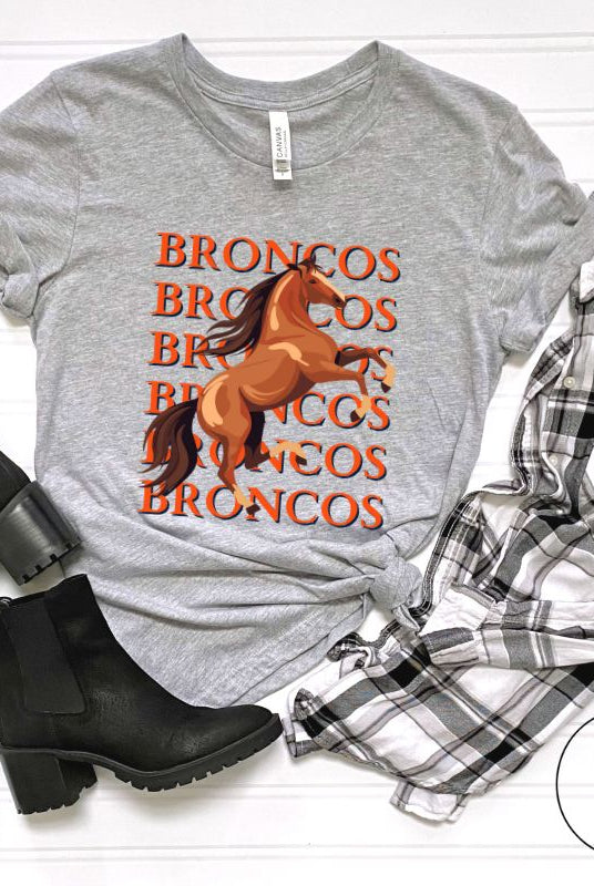 Saddle up for game day fun with our Bella Canvas 3001 unisex graphic tee! Gallop into Broncos spirit with our exclusive design featuring a lively Bronco horse and the spirited mantra "Broncos Broncos Broncos Broncos" on a grey shirt. 