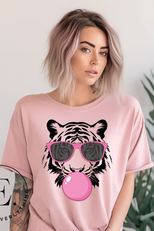 Bubble blowing tiger wearing pink sunglasses on a pink shirt. 