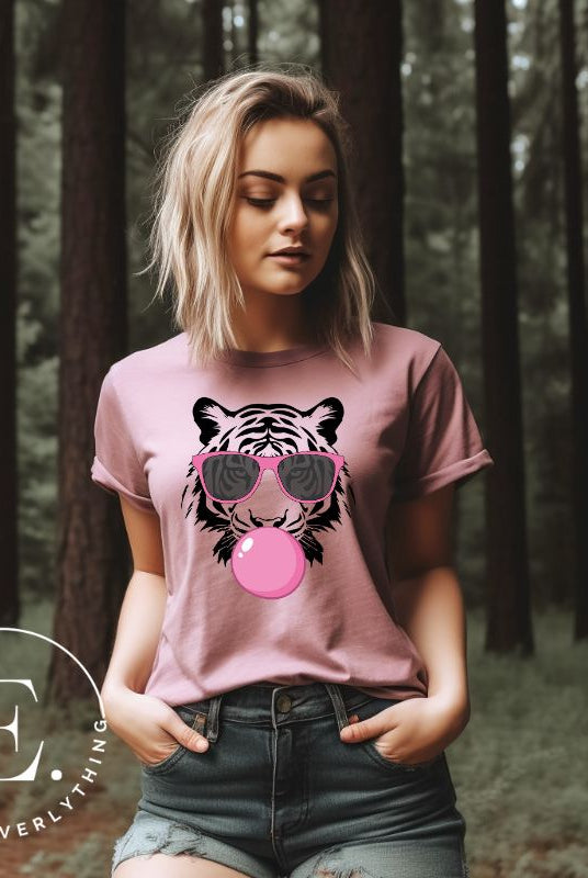 Bubble blowing tiger wearing pink sunglasses on a pink shirt.