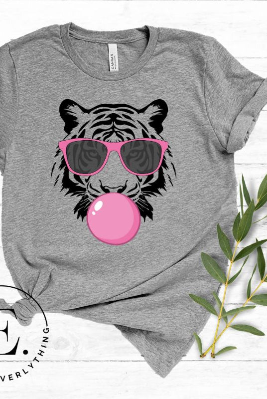 Bubble blowing tiger wearing pink sunglasses on a athletic grey shirt.