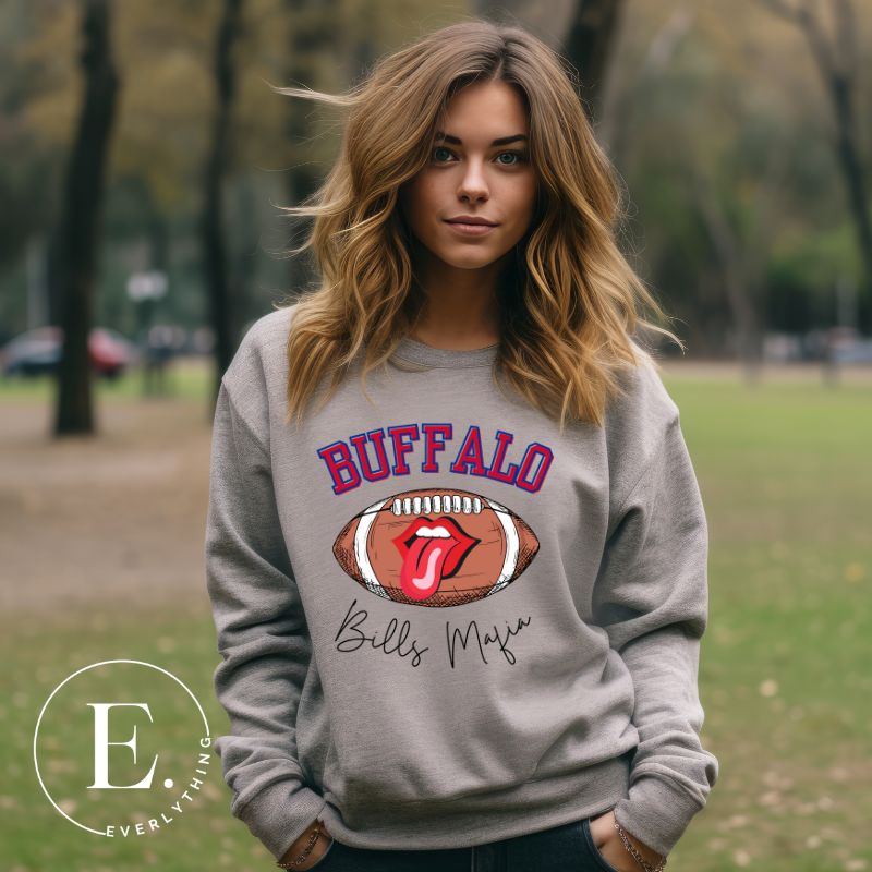 Show your Buffalo Bills pride with our premium sweatshirt featuring the team's name and iconic slogan, "Bills Mafia." On a grey sweatshirt. 