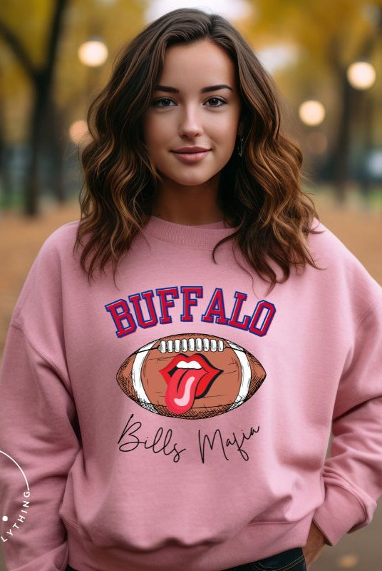 Show your Buffalo Bills pride with our premium sweatshirt featuring the team's name and iconic slogan, "Bills Mafia." On a pink sweatshirt. 