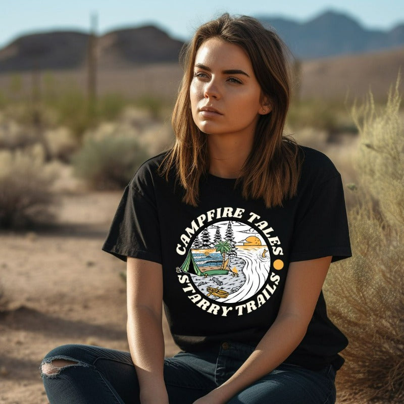 Black Bella + Canvas 3001 unisex t-shirt with a summer camping graphic design featuring a tent, campfire, and starry sky with the words 'Campfire Tales, Starry Trails' around the image.