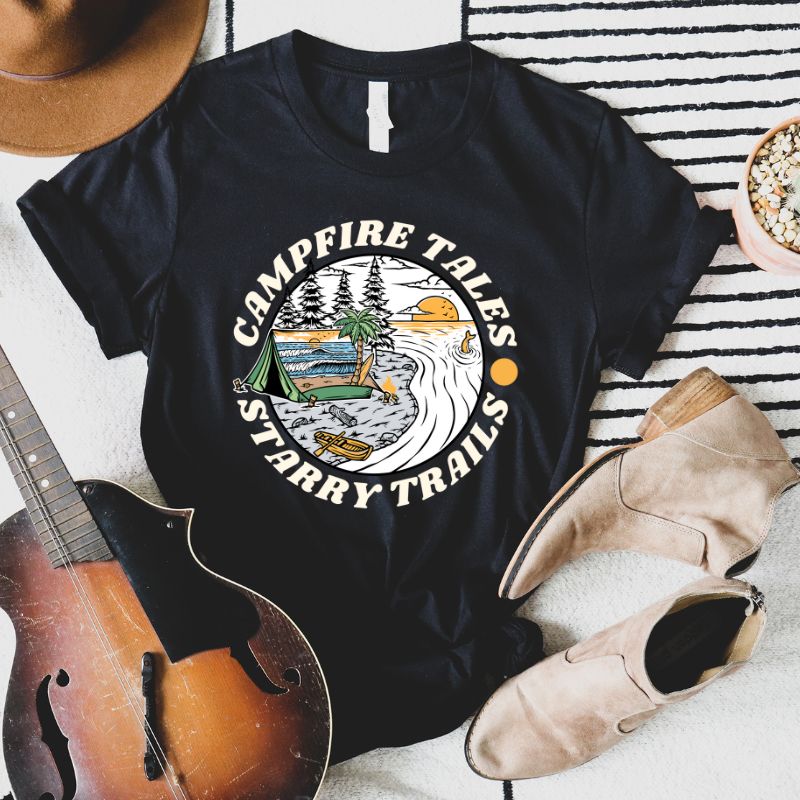 Black Bella + Canvas 3001 unisex t-shirt with a summer camping graphic design featuring a tent, campfire, and starry sky with the words 'Campfire Tales, Starry Trails' around the image.