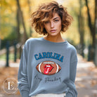 Support the Carolina Panthers in style with our modern and trendy sweatshirt featuring the team's name and powerful teams slogan, "Keep Pounding."  On a blue sweatshirt. 